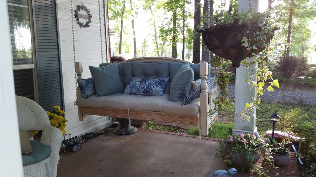 headboard from bed converted to porch swing